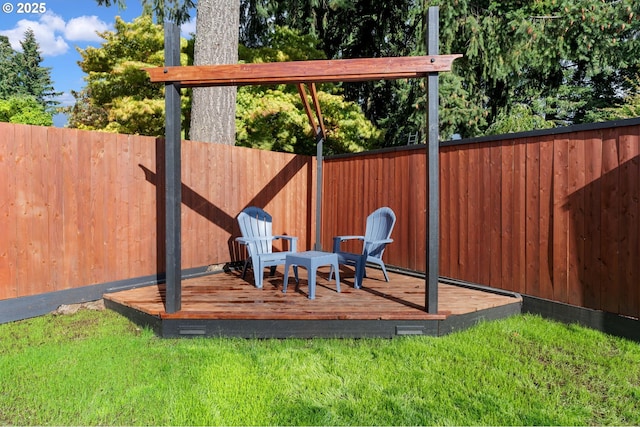 view of playground featuring a wooden deck, a yard, and a fenced backyard