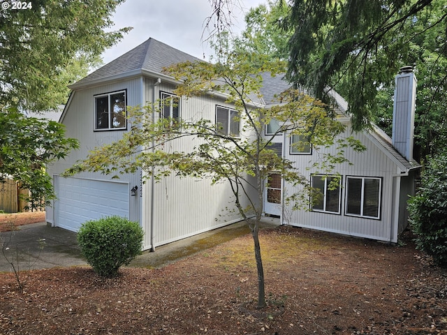 view of side of home featuring a garage