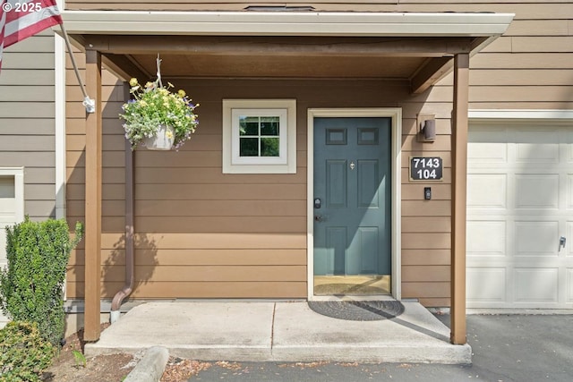 7143 SW Sagert St Unit 104, Tualatin, OR 97062 - view of exterior entry featuring a garage