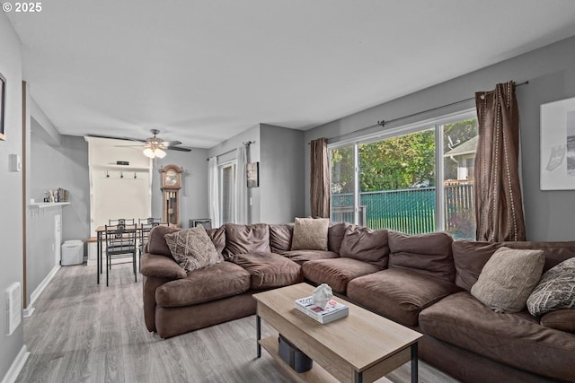 7143 SW Sagert St Unit 104, Tualatin, OR 97062 - living area with light wood-style floors, a ceiling fan, and baseboards