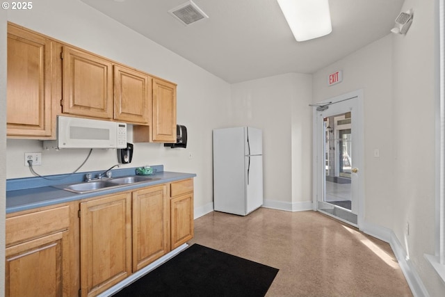 7143 SW Sagert St Unit 104, Tualatin, OR 97062 - kitchen with white appliances, a sink, and baseboards