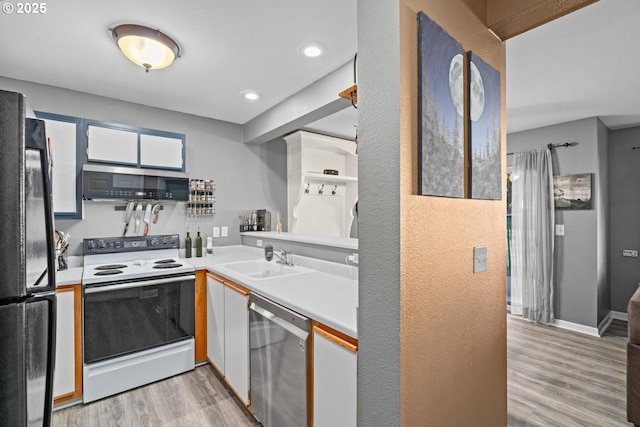 7143 SW Sagert St Unit 104, Tualatin, OR 97062 - kitchen with appliances with stainless steel finishes, a sink, light wood-style flooring, light countertops, and a textured wall