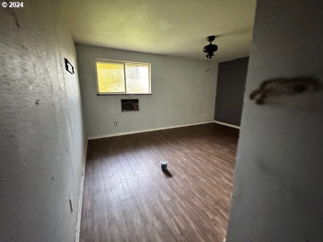 empty room with dark hardwood / wood-style floors