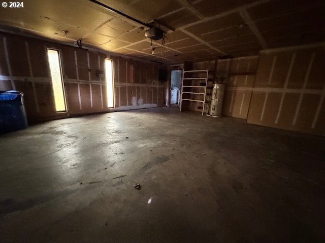 garage featuring a garage door opener and water heater