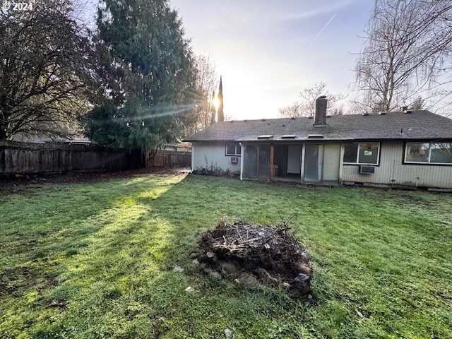 rear view of house with a lawn