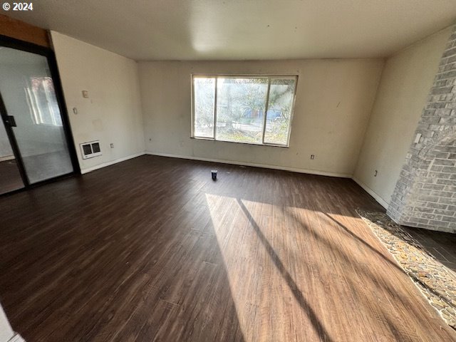 spare room with dark hardwood / wood-style floors