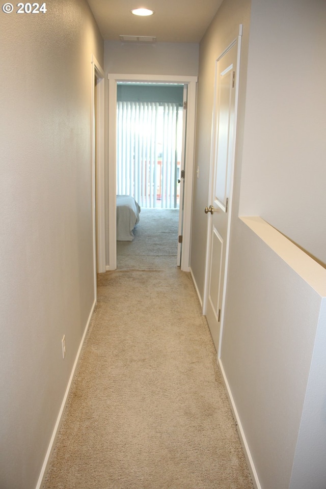 hallway with light carpet