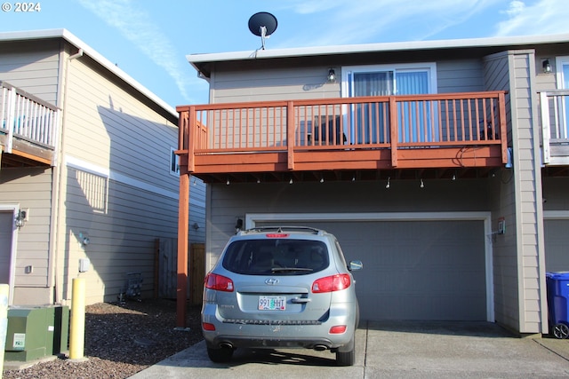 back of property featuring a balcony and a garage