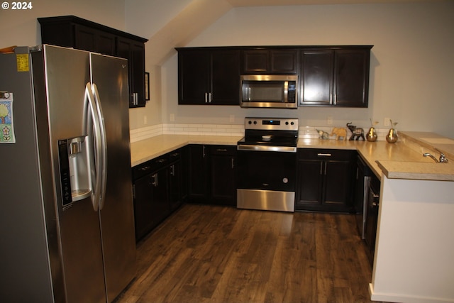 kitchen with dark hardwood / wood-style floors and appliances with stainless steel finishes