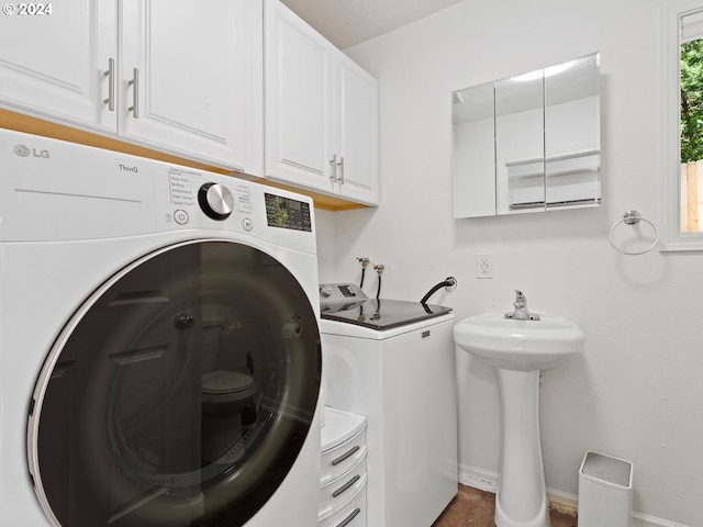 clothes washing area with washing machine and dryer and sink