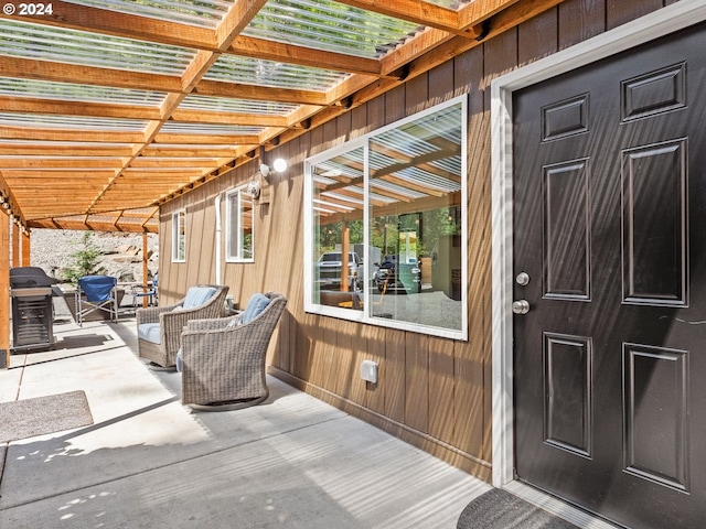 exterior space with grilling area and a pergola