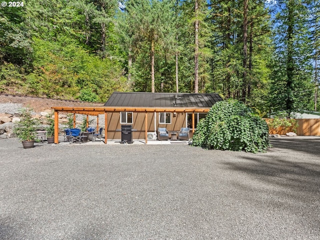 view of front of home with an outdoor structure and a patio area