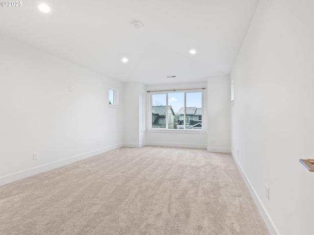 unfurnished room featuring baseboards, visible vents, light colored carpet, and recessed lighting