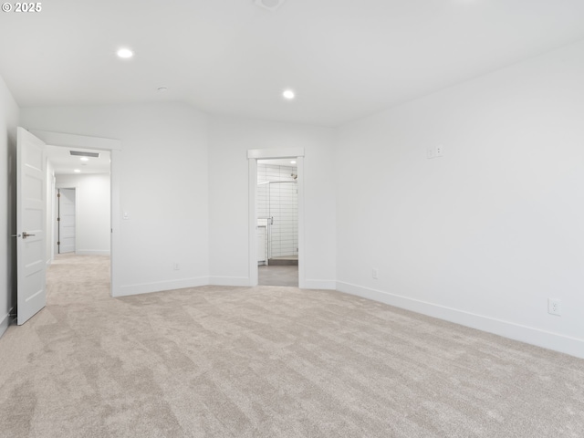 unfurnished bedroom featuring lofted ceiling, recessed lighting, baseboards, and light colored carpet