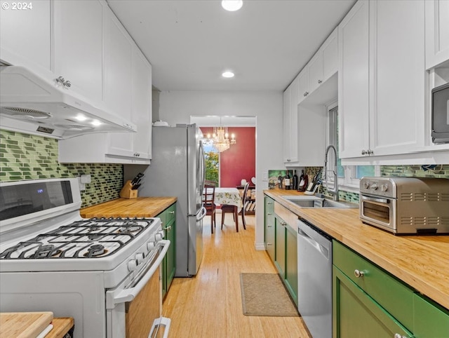 kitchen with green cabinets, sink, white cabinets, appliances with stainless steel finishes, and light hardwood / wood-style floors