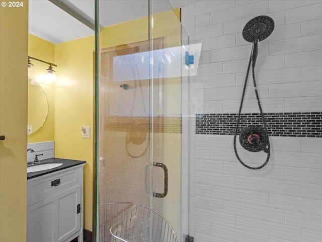 bathroom featuring vanity and a shower with shower door