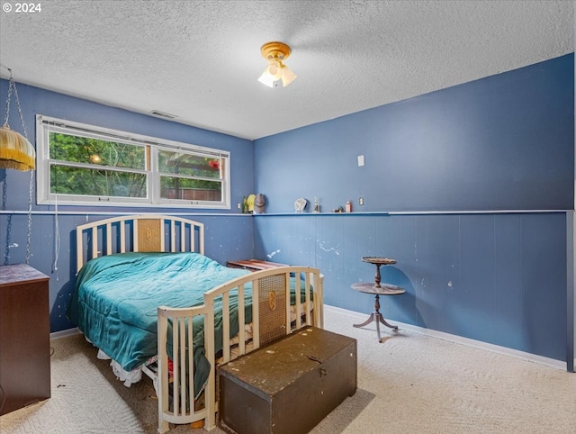 bedroom featuring a textured ceiling and carpet