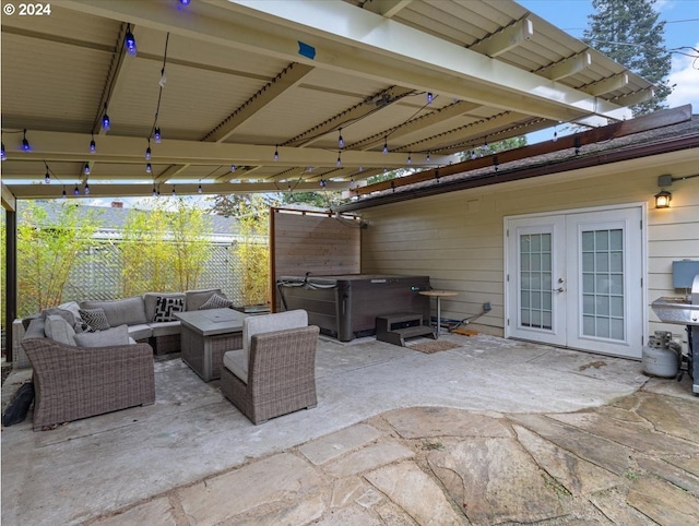 view of patio featuring a hot tub, an outdoor hangout area, and french doors