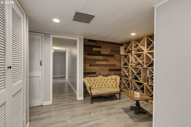 living area featuring a textured ceiling and light wood-type flooring