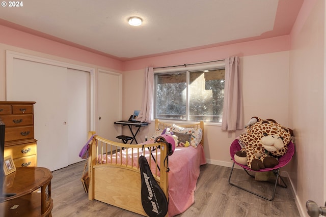 bedroom featuring a closet and light wood-type flooring