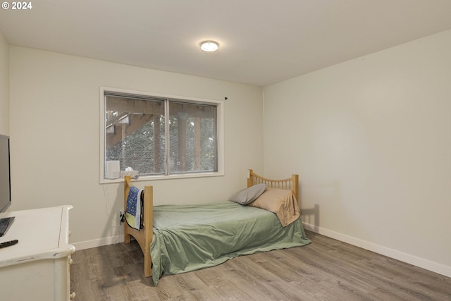 bedroom with hardwood / wood-style floors