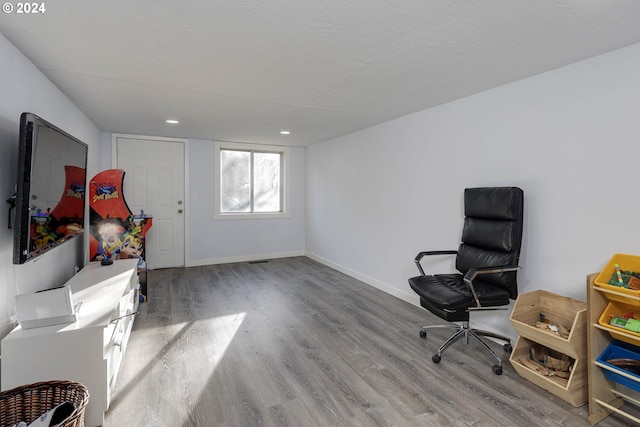 sitting room with a textured ceiling and hardwood / wood-style flooring