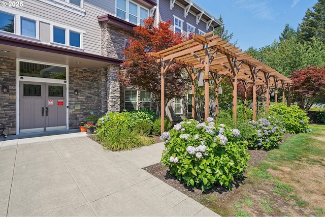 doorway to property with a pergola