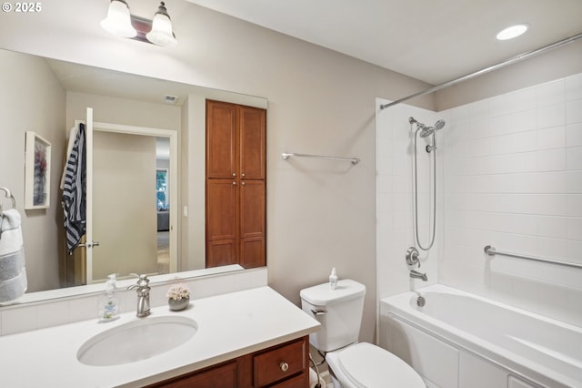 full bathroom with vanity, toilet, and tiled shower / bath