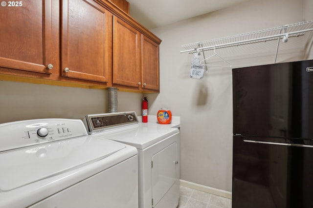 washroom featuring cabinets and washing machine and dryer