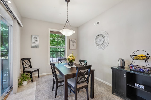 dining area with light carpet and plenty of natural light