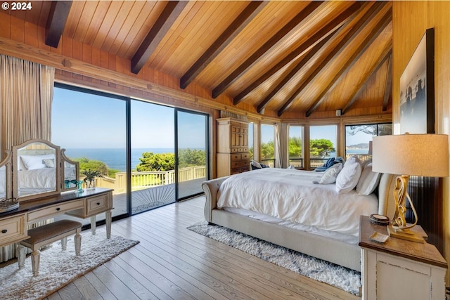 bedroom featuring access to exterior, light hardwood / wood-style flooring, wooden walls, a water view, and wood ceiling