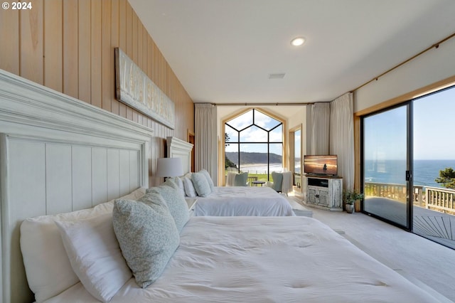 carpeted bedroom with wood walls and access to exterior