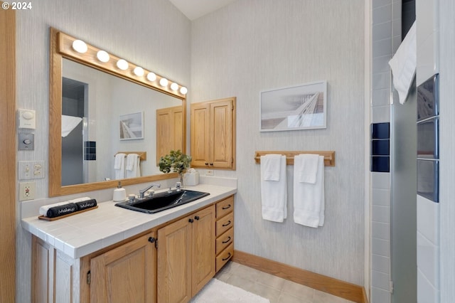 bathroom with tile patterned flooring and vanity