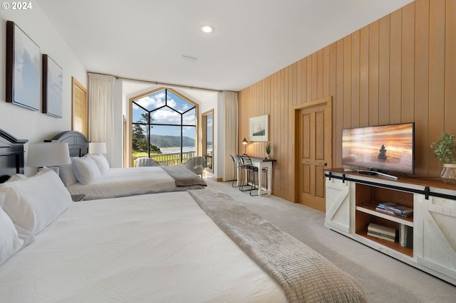 carpeted bedroom with wooden walls