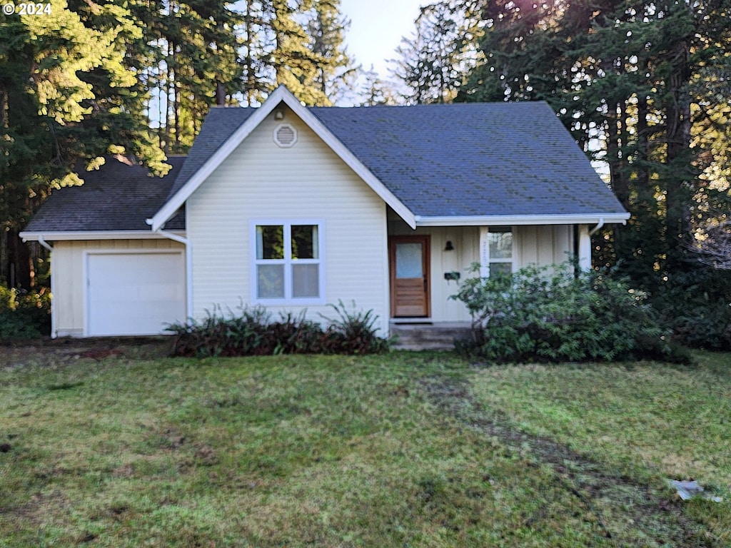 view of front facade with a front lawn and a garage