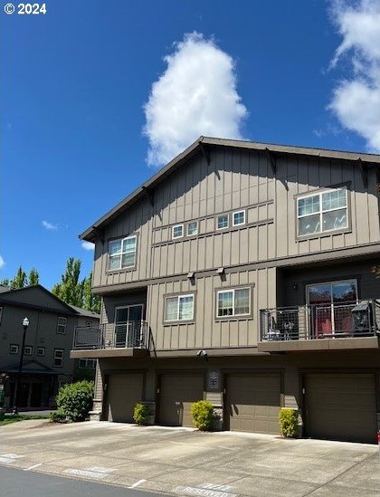 exterior space with a balcony and a garage