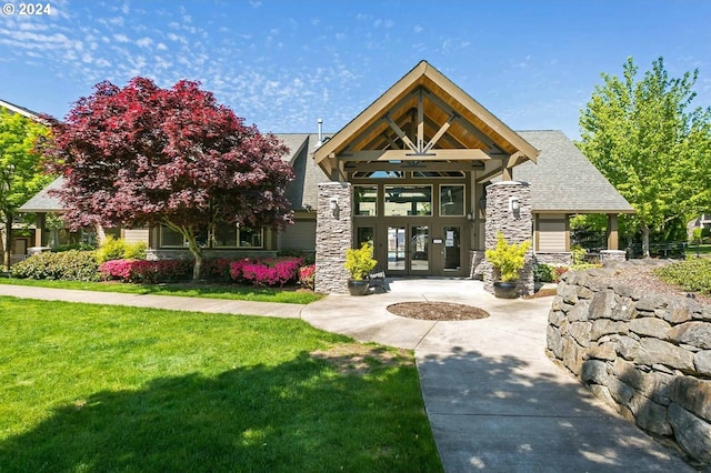 view of front facade with french doors and a front yard