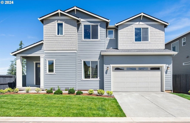 view of front facade with a garage and a front lawn