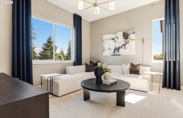 living room with light carpet and a chandelier