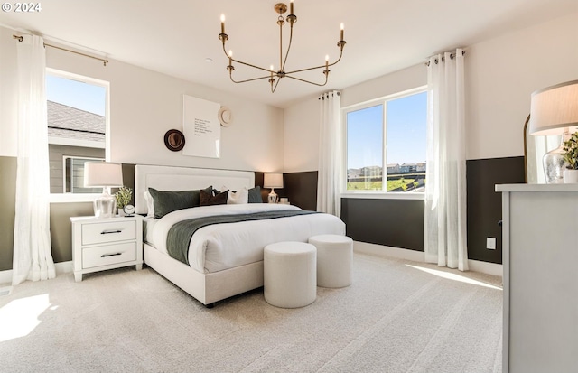 carpeted bedroom featuring a notable chandelier and multiple windows