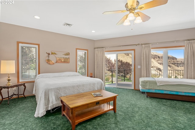 carpeted bedroom featuring ceiling fan, a mountain view, and access to exterior