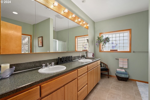 bathroom with tile patterned floors, an enclosed shower, and vanity