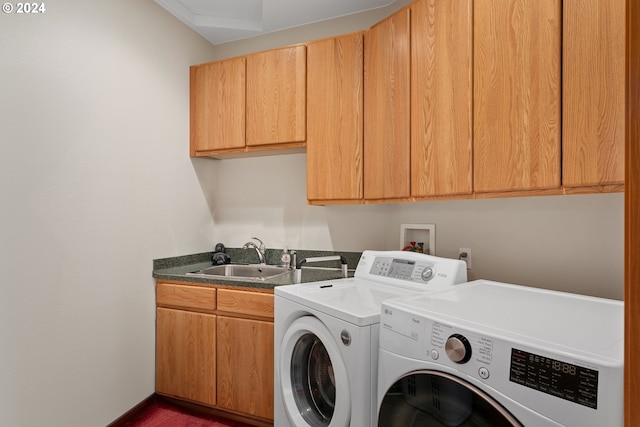 laundry room featuring washer and dryer, cabinets, and sink