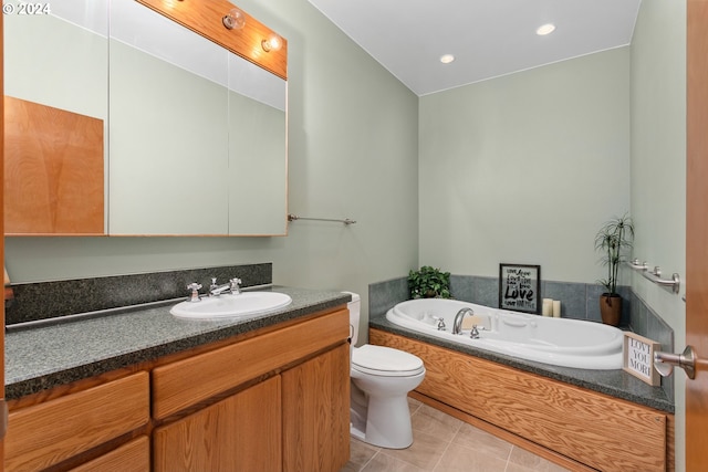 bathroom with a tub to relax in, vanity, toilet, and tile patterned floors