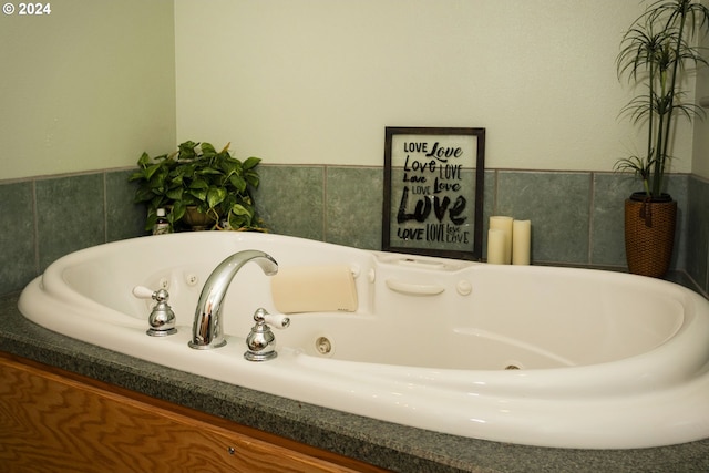 bathroom with tile walls and a bathtub