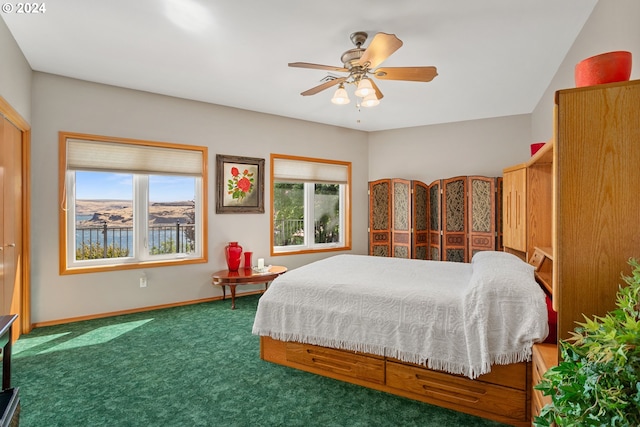 bedroom featuring dark colored carpet and ceiling fan