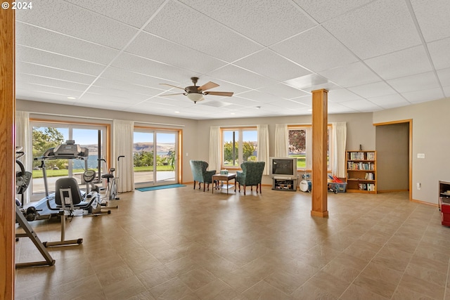 workout room with ornate columns, a paneled ceiling, and ceiling fan