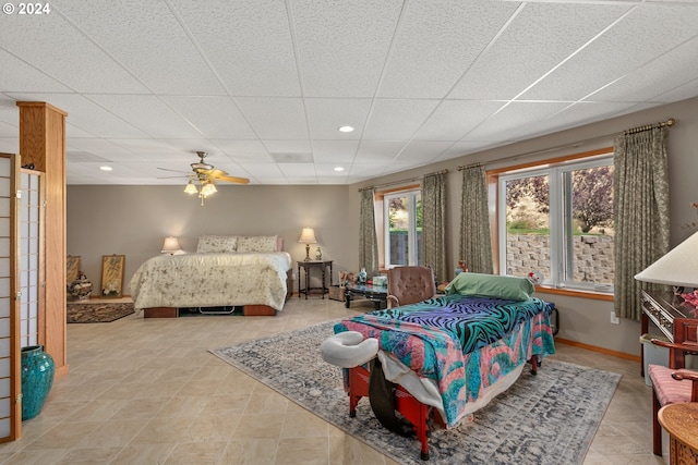 bedroom featuring ceiling fan and a drop ceiling