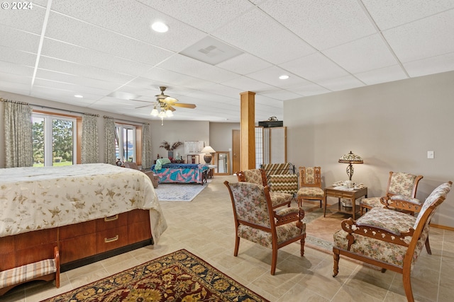 bedroom featuring ceiling fan and a drop ceiling