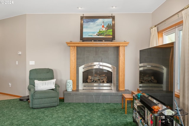 sitting room featuring carpet and a fireplace